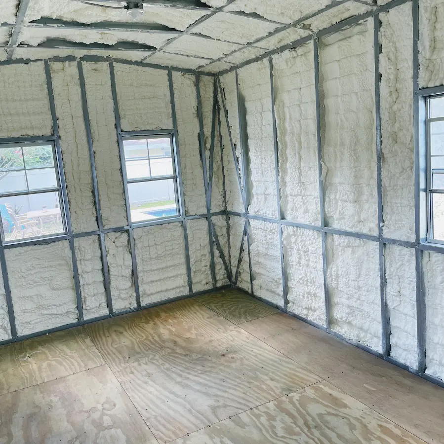 Closed-cell spray foam insulation applied to wall cavities in a residential project in Greenfield